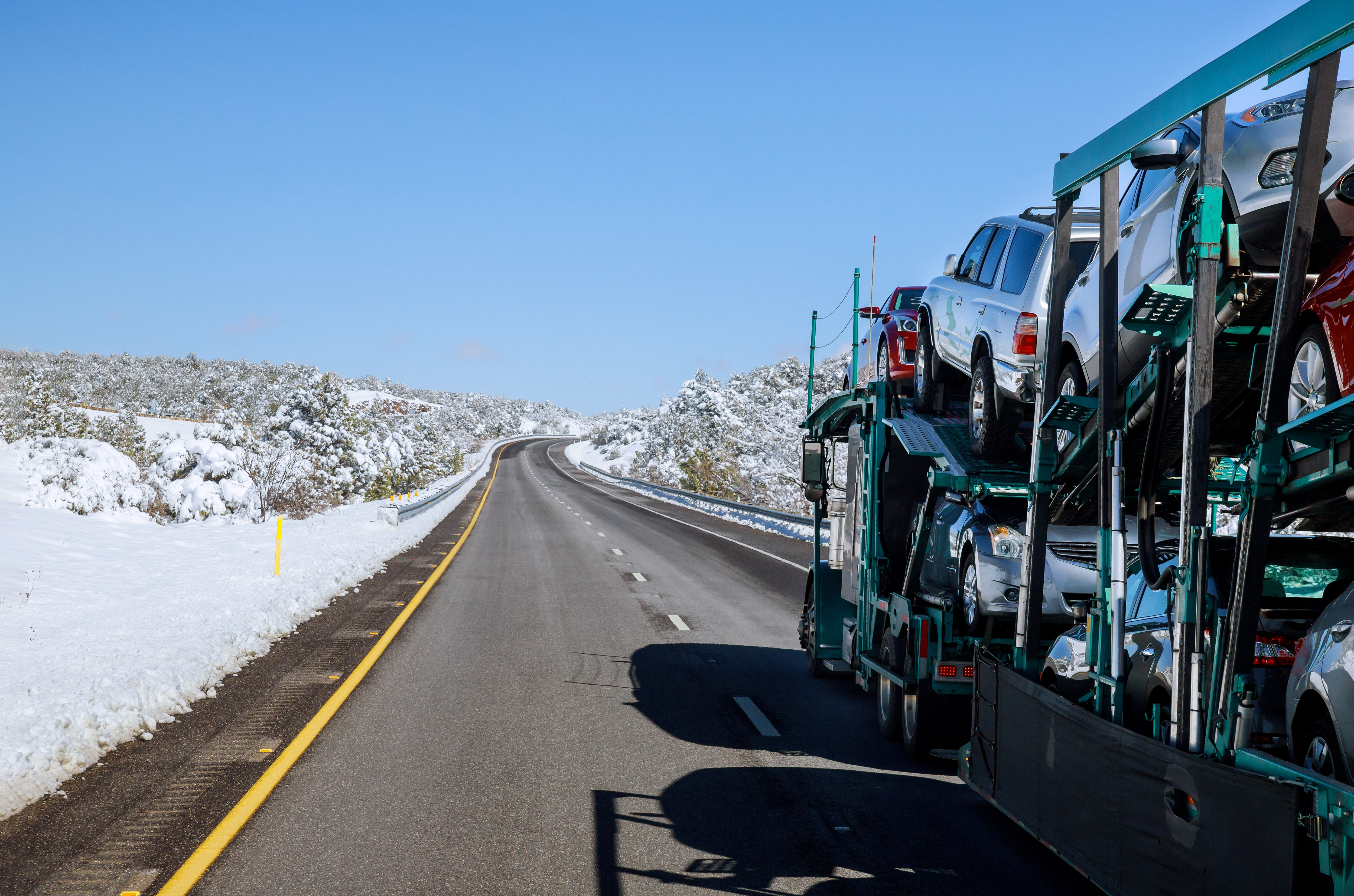 Car carrier truck on a winter highway